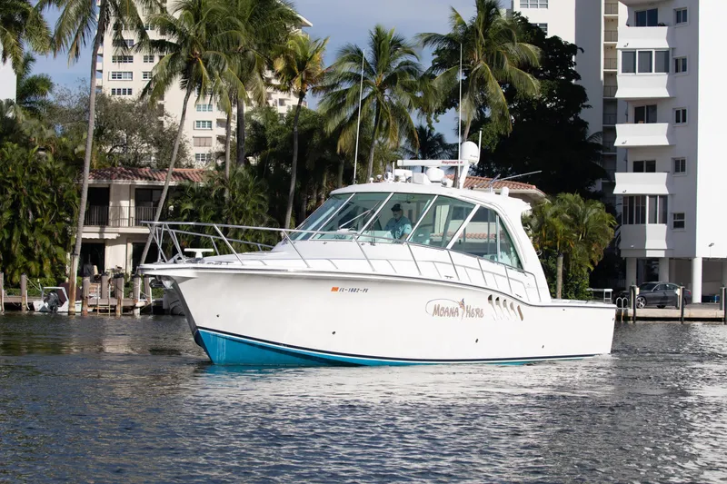 Slide: The Image of 2015 Albemarle 360 Express Fisherman boat on water near palm trees and buildings. - 5
