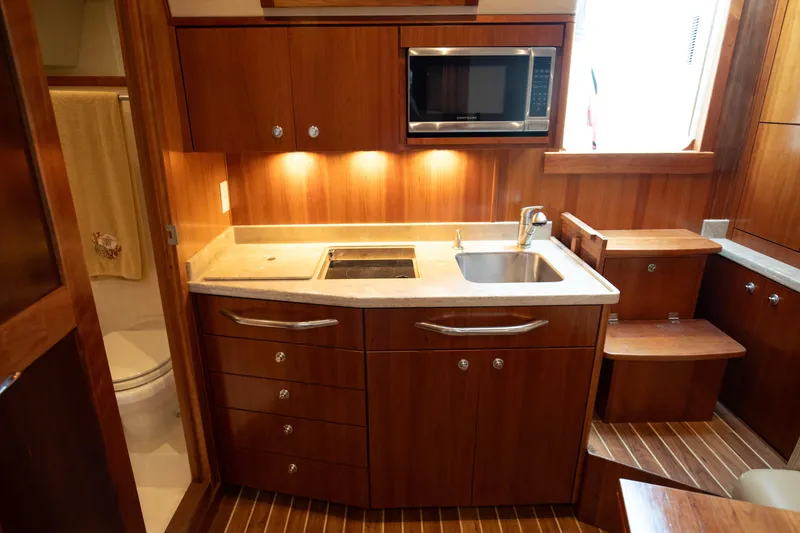 Slide: The Image of 2015 Albemarle 360 Express Fisherman yacht kitchen with wood cabinetry and modern appliances. - 52
