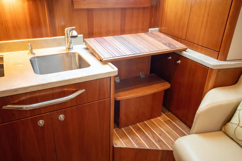 Slide: The Image of 2015 Albemarle 360 Express Fisherman interior with wooden cabinetry and sink. - 53
