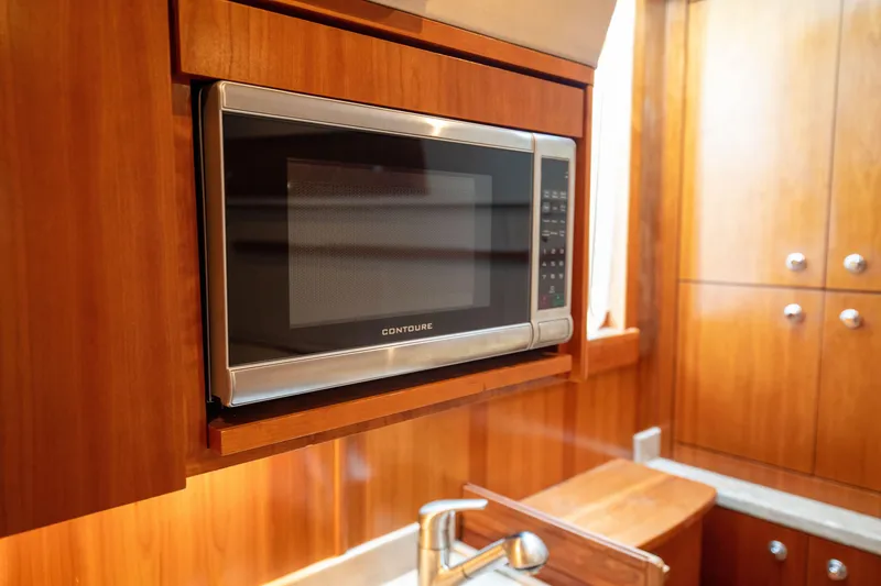 Slide: The Image of Microwave in 2015 Albemarle 360 Express Fisherman yacht kitchen, featuring wooden cabinetry. - 55