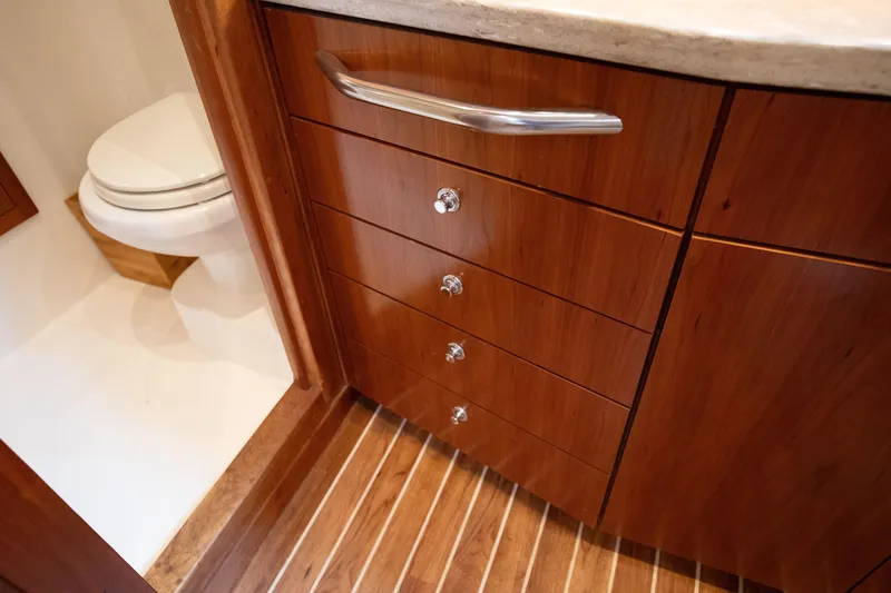 Slide: The Image of 2015 Albemarle 360 Express Fisherman bathroom with wooden cabinetry and toilet. - 61