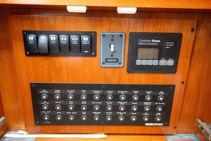 Slide: The Image of Control panel of a 2015 Albemarle 360 Express Fisherman boat with switches and generator display. - 66