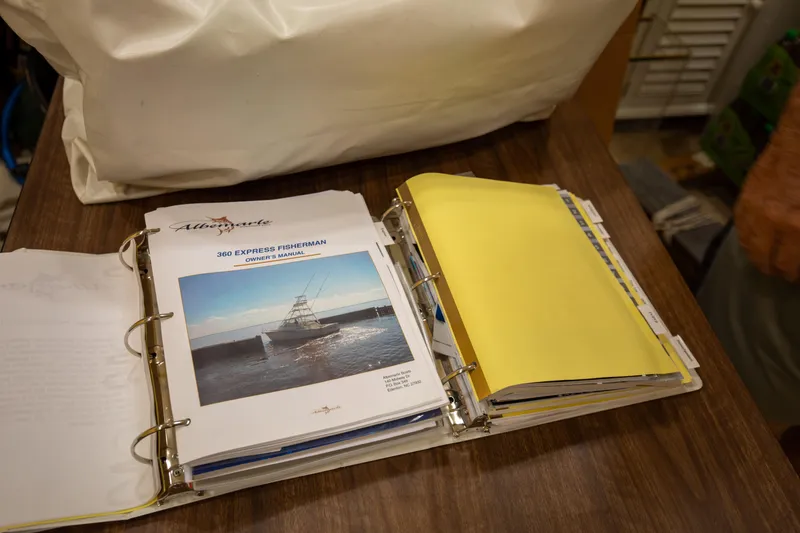 Slide: The Image of Owner's manual for 2015 Albemarle 360 Express Fisherman on a wooden table. - 80