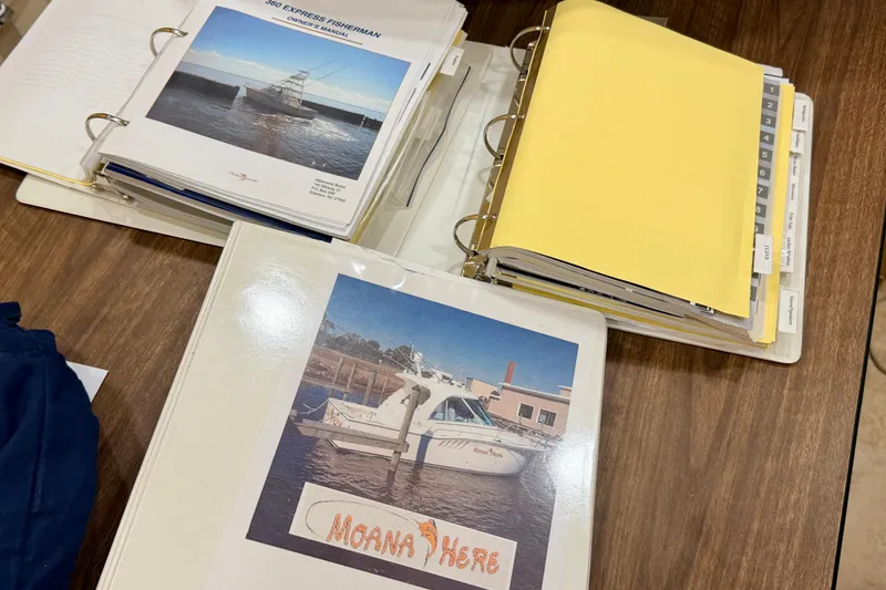 Slide: The Image of Binders with manuals for 2015 Albemarle 360 Express Fisherman on a wooden table. - 81