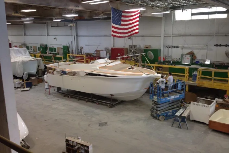 Slide: The Image of 2015 Albemarle 360 Express Fisherman under construction in a workshop with American flag. - 85
