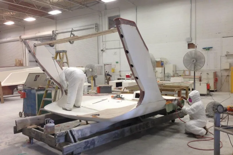 Slide: The Image of Workers assembling 2015 Albemarle 360 Express Fisherman boat in a factory setting. - 86