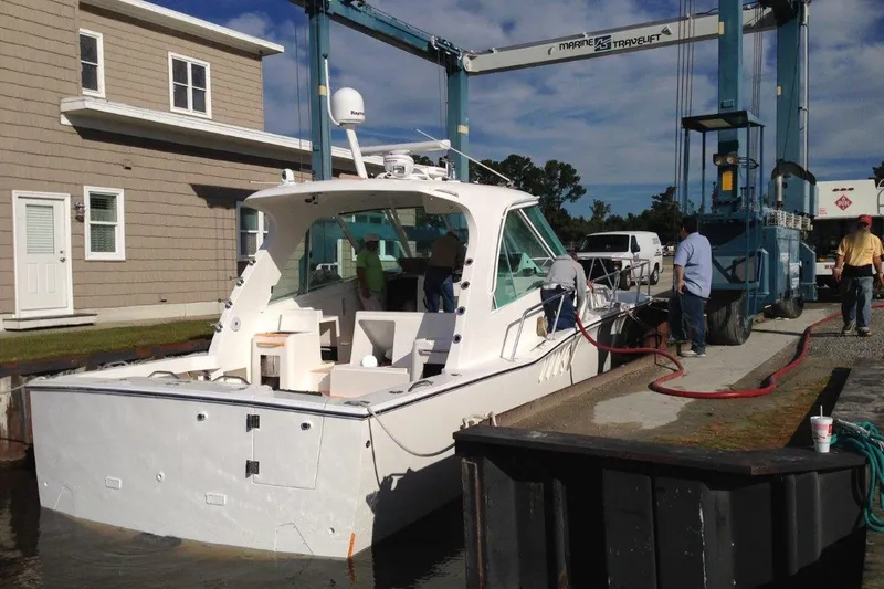 Slide: The Image of 2015 Albemarle 360 Express Fisherman boat at dockside with crew and equipment. - 89
