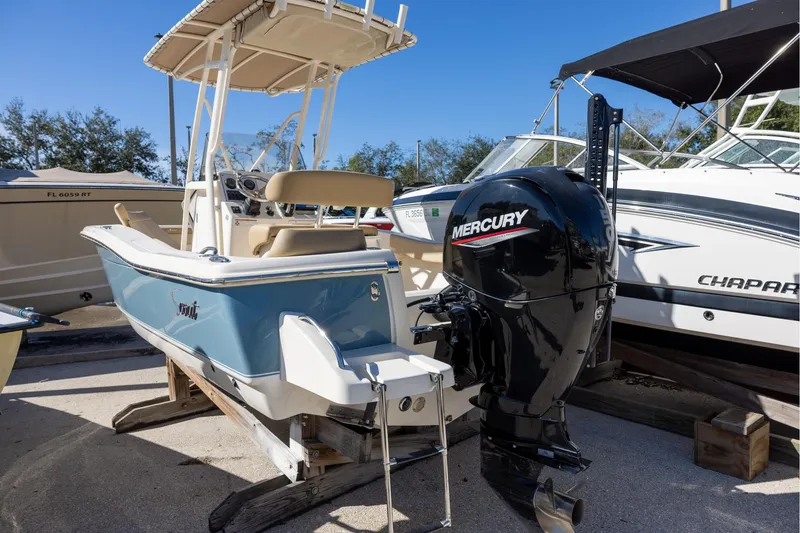 Slide: The Image of 2020 Scout 195 Sportfish boat with Mercury outboard motor, parked on a trailer. - 2