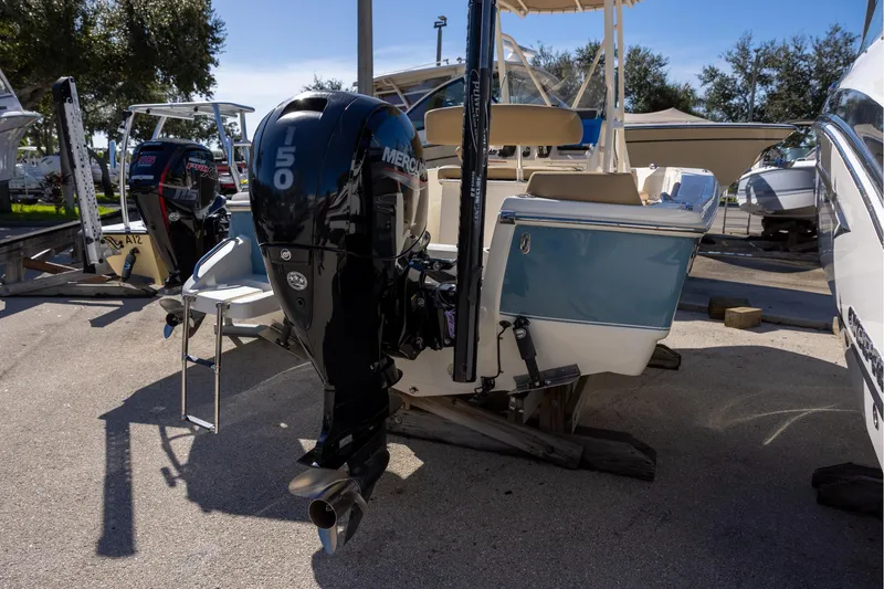 Slide: The Image of 2020 Scout 195 Sportfish boat with Mercury 150 outboard engine, parked outdoors. - 3