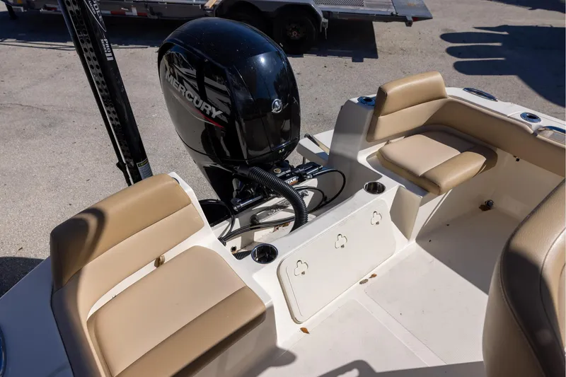 Slide: The Image of 2020 Scout 195 Sportfish boat interior with Mercury engine and tan seating. - 5