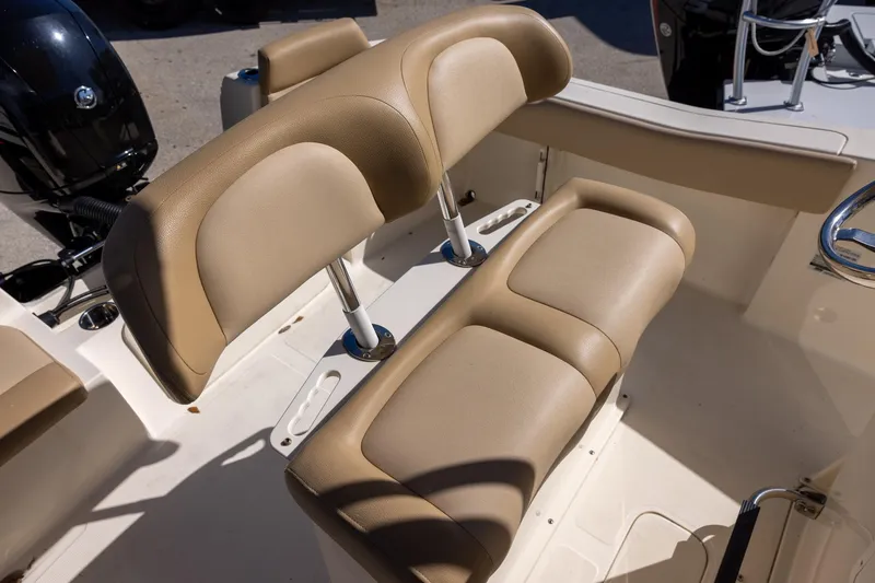 Slide: The Image of 2020 Scout 195 Sportfish boat with tan cushioned seating and steering wheel. - 6