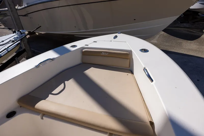 Slide: The Image of 2020 Scout 195 Sportfish boat interior with beige seating and stainless steel fixtures. - 7