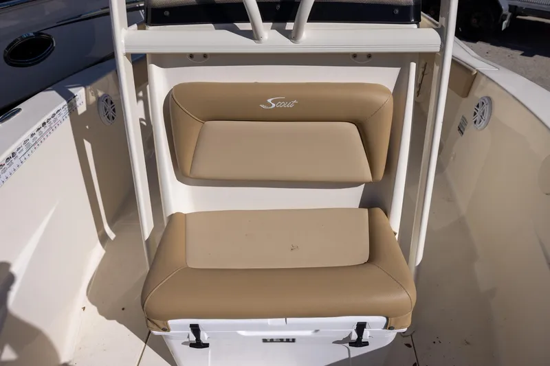 Slide: The Image of 2020 Scout 195 Sportfish boat seat with tan cushions and white frame. - 8