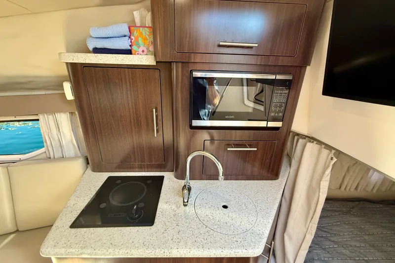 Slide: The Image of Interior of 2018 Regal 28 Express with kitchenette and microwave. - 14
