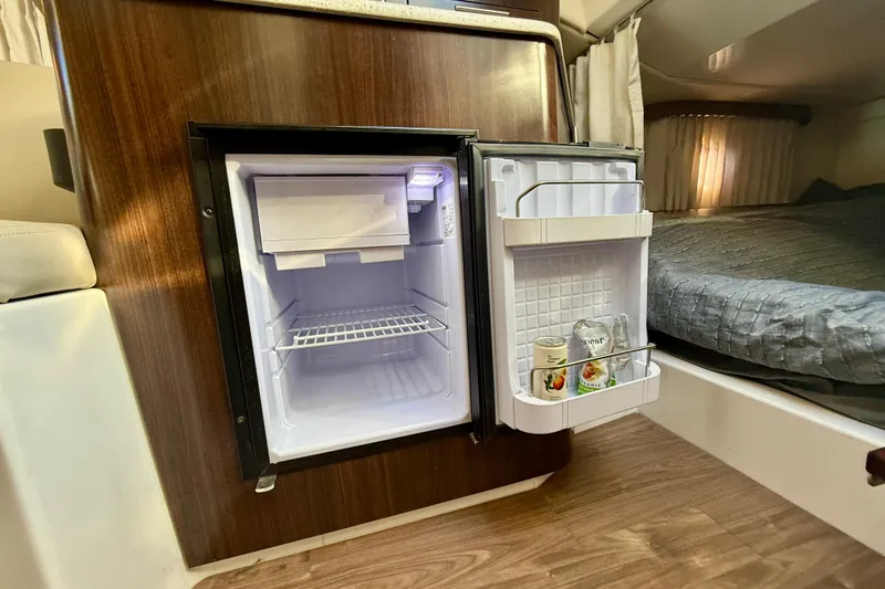 Slide: The Image of Compact fridge in 2018 Regal 28 Express boat cabin, with drinks stored inside. - 21
