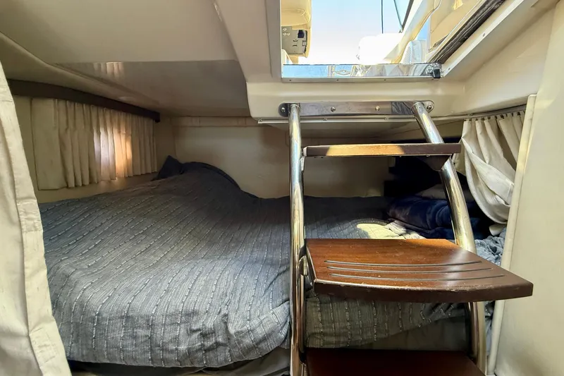 Slide: The Image of 2018 Regal 28 Express cabin interior with bed and wooden steps. - 24