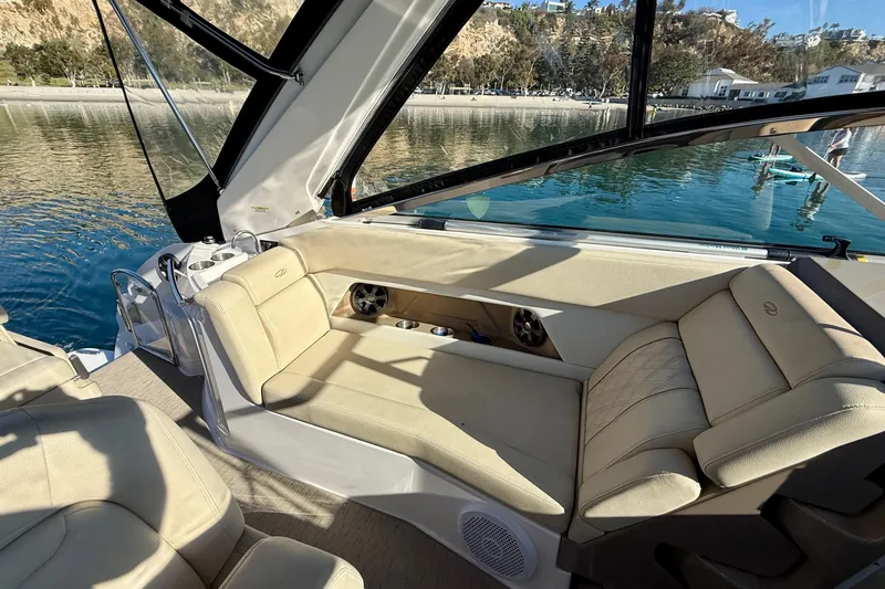Slide: The Image of Luxurious interior of 2018 Regal 28 Express boat with beige seating and scenic water view. - 26
