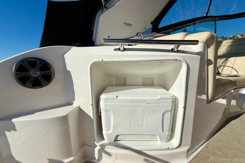 Slide: The Image of 2018 Regal 28 Express boat interior with cooler storage and speaker. - 36