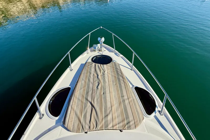 Slide: The Image of Bow view of 2018 Regal 28 Express boat on calm water. - 38