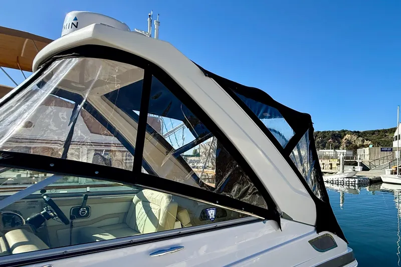 Slide: The Image of 2018 Regal 28 Express boat with clear canopy, docked under blue sky. - 42