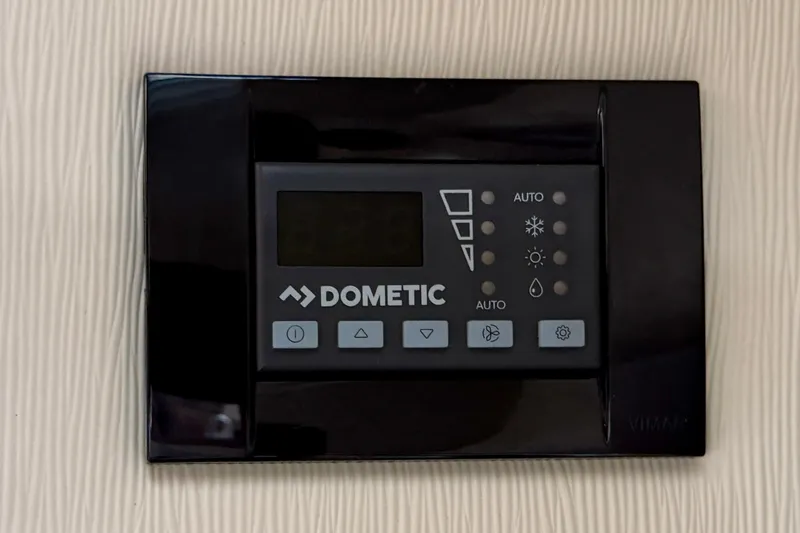 Slide: The Image of Dometic control panel on 2018 Regal 28 Express boat interior. - 43