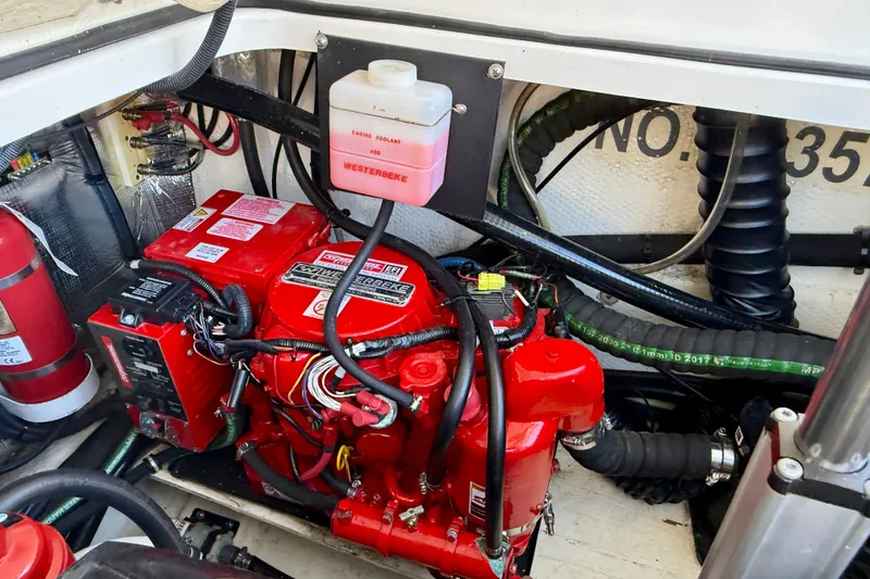 Slide: The Image of Engine compartment of 2018 Regal 28 Express with Westerbeke generator and coolant system. - 46