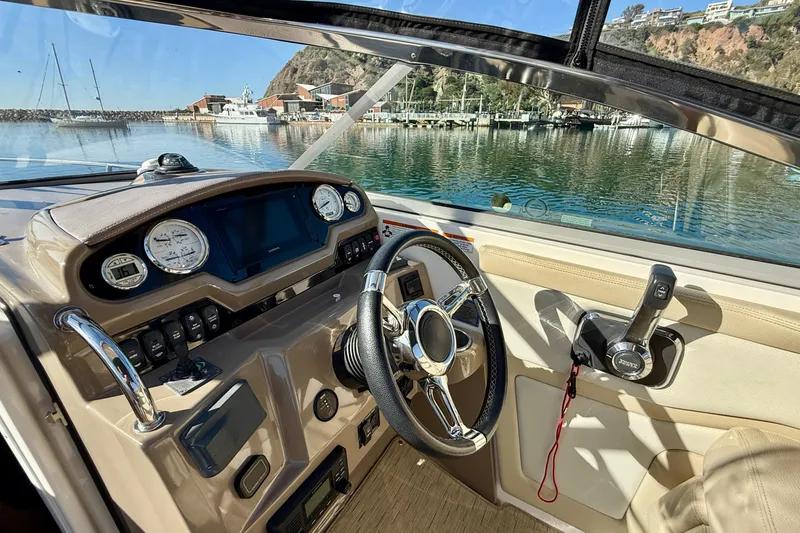 Slide: The Image of Cockpit view of 2018 Regal 28 Express boat with steering wheel and controls. - 7