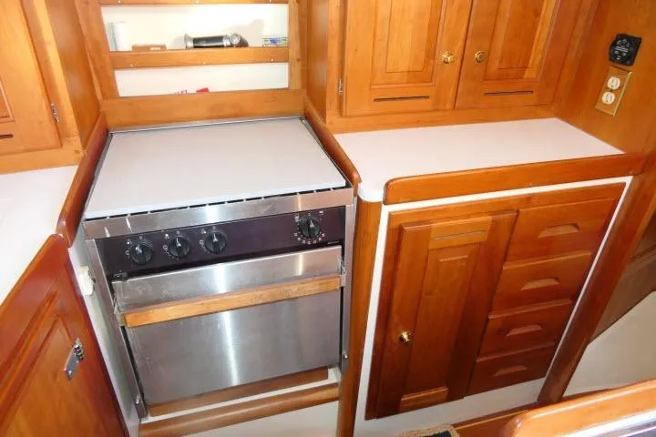 Slide: The Image of Wooden kitchen interior of 2002 Tartan 3700 yacht with stove and cabinets. - 15