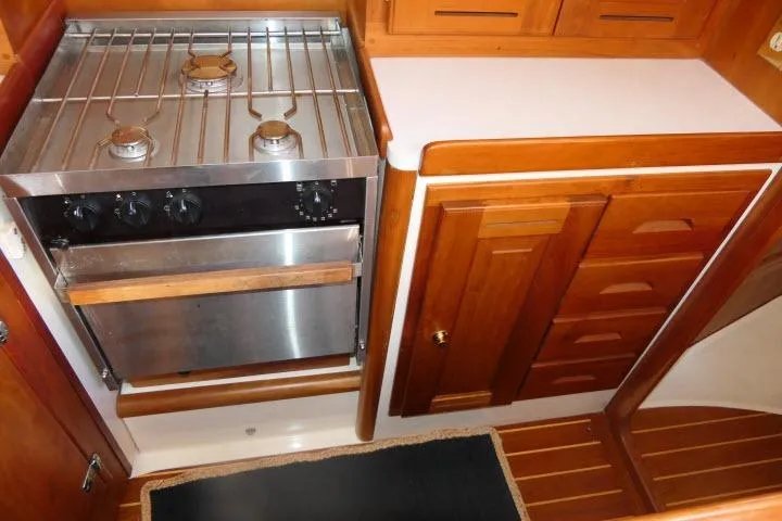 Slide: The Image of Wooden yacht kitchen with stainless steel stove, Tartan 3700, 2002 model. - 16