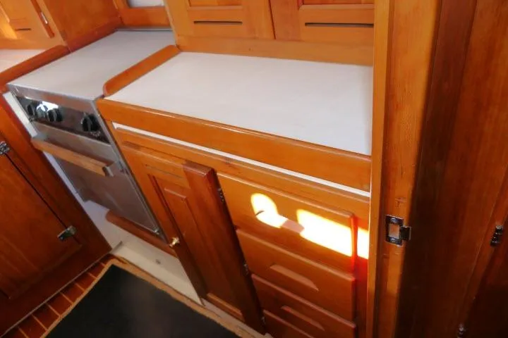 Slide: The Image of Wooden kitchen interior of 2002 Tartan 3700 yacht with stove and cabinets. - 20