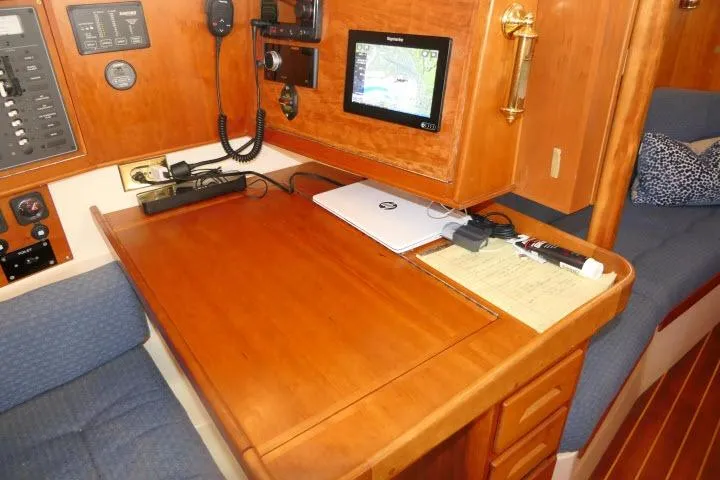 Slide: The Image of Navigation station in 2002 Tartan 3700 sailboat with chart plotter and communication equipment. - 27