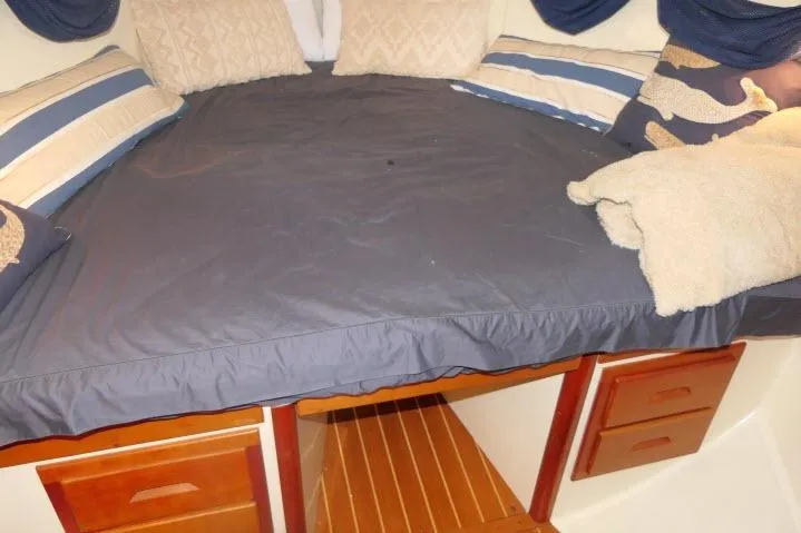 Slide: The Image of Cozy cabin bed in 2002 Tartan 3700 sailboat with pillows and wooden drawers. - 28