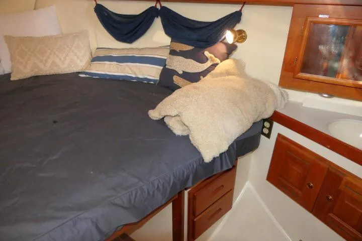 Slide: The Image of Cozy cabin interior of 2002 Tartan 3700 sailboat with bed and wooden cabinets. - 31