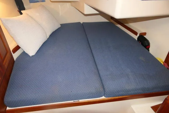 Slide: The Image of Interior cabin of 2002 Tartan 3700 sailboat with blue bedding and pillows. - 34