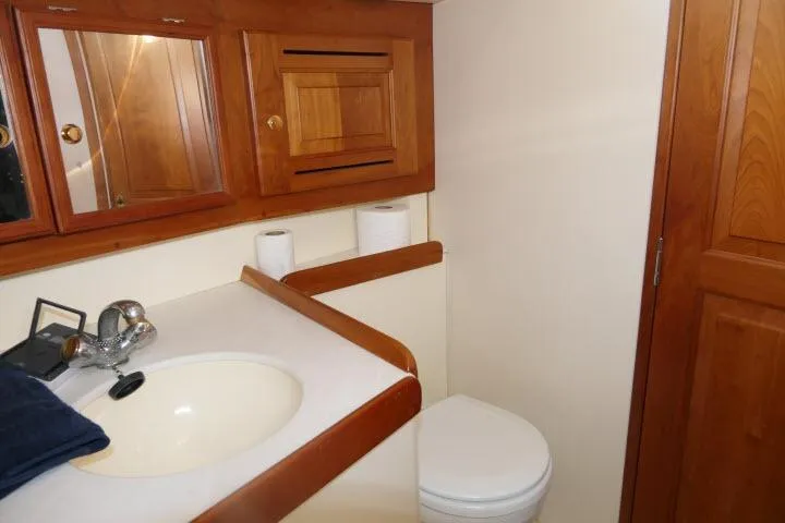 Slide: The Image of Bathroom interior of 2002 Tartan 3700 yacht with wooden cabinets and white fixtures. - 40