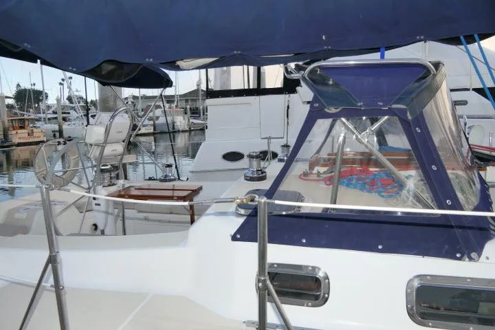 Slide: The Image of 2002 Tartan 3700 sailboat docked at marina, featuring cockpit and canopy. - 45