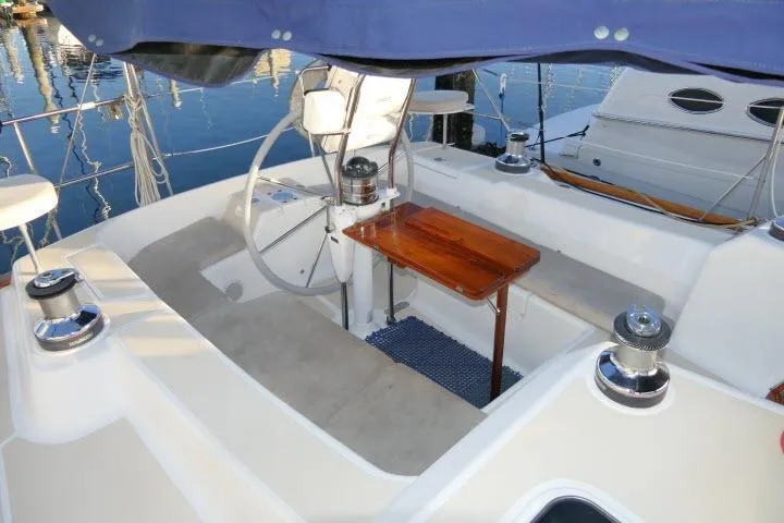 Slide: The Image of Cockpit of 2002 Tartan 3700 sailboat with steering wheel and wooden table. - 47