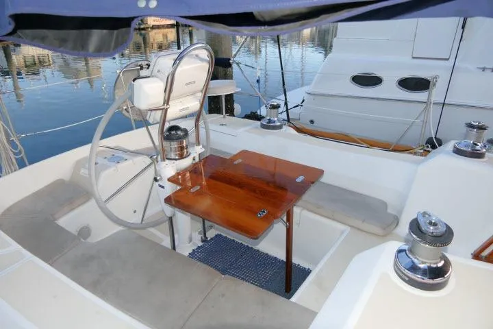 Slide: The Image of Cockpit of 2002 Tartan 3700 sailboat with wooden table and steering wheel. - 49