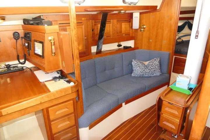 Slide: The Image of Interior of 2002 Tartan 3700 sailboat with blue sofa and wooden cabinetry. - 5