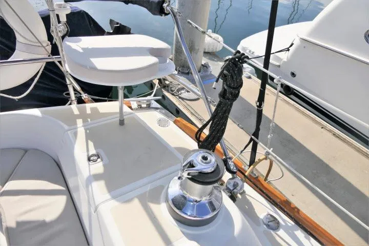 Slide: The Image of Tartan 3700 sailboat deck, 2002 model, featuring winch and seating area. - 52