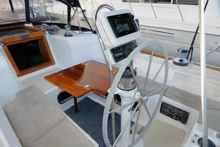 Slide: The Image of Cockpit of 2002 Tartan 3700 sailboat with steering wheel and navigation equipment. - 54
