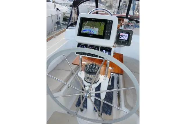 Slide: The Image of Steering wheel and navigation equipment on a 2002 Tartan 3700 sailboat. - 58
