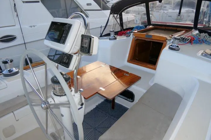 Slide: The Image of Cockpit of 2002 Tartan 3700 sailboat with steering wheel and navigation equipment. - 59