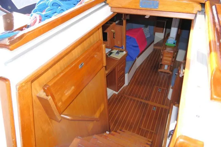 Slide: The Image of Interior view of 2002 Tartan 3700 sailboat, featuring wooden cabinetry and flooring. - 63