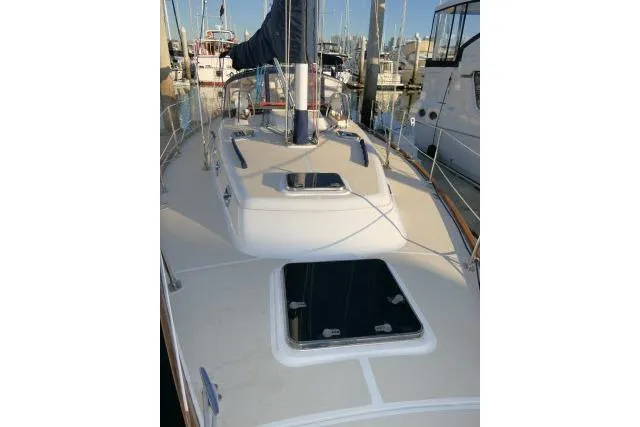 Slide: The Image of 2002 Tartan 3700 sailboat deck view at marina, showcasing sleek design and rigging. - 69