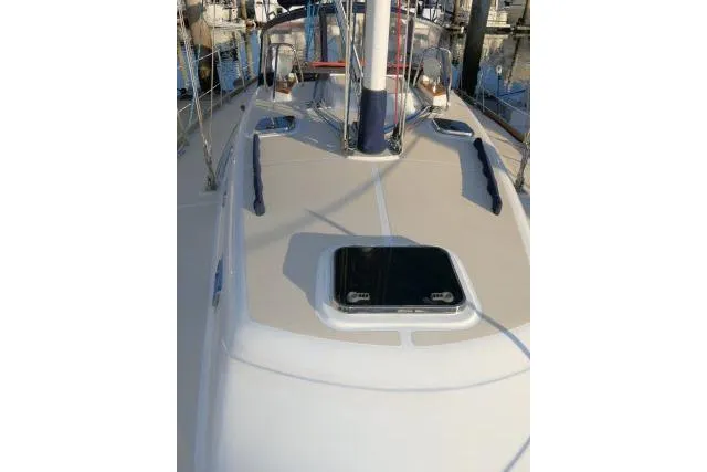 Slide: The Image of 2002 Tartan 3700 sailboat deck with hatch, docked in marina. - 70