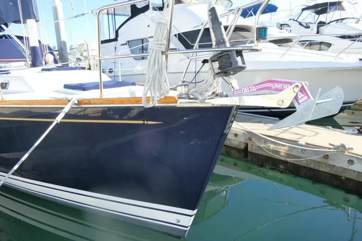 Slide: The Image of Sailboat Tartan 3700, 2002 model, docked in marina with visible anchor. - 73