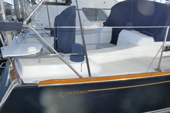 Slide: The Image of Tartan 3700 sailboat, 2002 model, docked with blue covers and sleek design. - 79