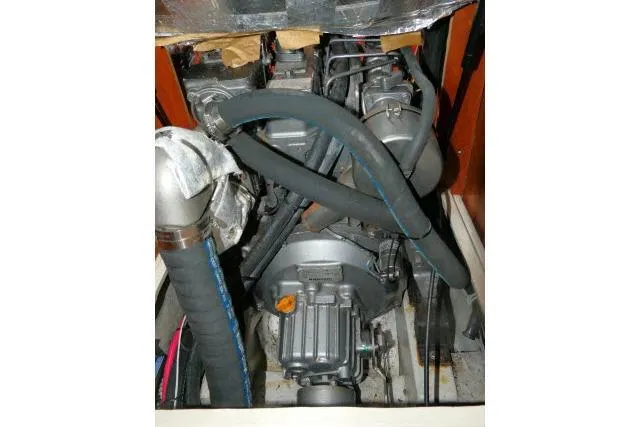 Slide: The Image of Engine compartment of a 2002 Tartan 3700 sailboat, showcasing mechanical components and hoses. - 87
