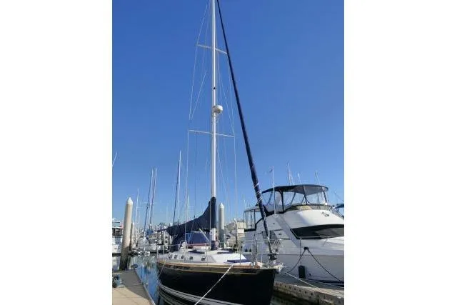 Slide: The Image of Sailboat docked at marina, Tartan 3700, 2002 model, under clear blue sky. - 91